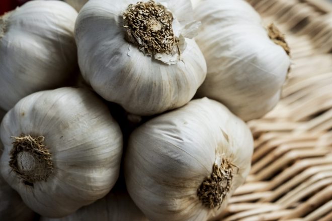 High angle view of a few garlic bulbs in a basket.