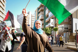 A PALESTINIAN WOMAN WAVES A FLAG DURING A PRO-PALESTINIAN PROTEST IN BEIRUT