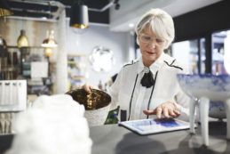 Senior woman with tablet shopping in home goods store