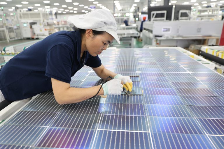 A Chinese worker in a solar panel assembly line that ships product to Brazil: energy industry professionals are relocating to the country