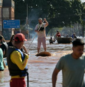 Homem utiliza equipamento empregado no mar para se deslocar entre ruas alagadas de Porto Alegre