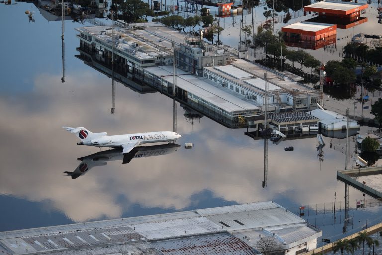 An aerial view shows the flooded tarmac of Salgado Filho International Airport in the city of Porto Alegre, Rio Grande do Sul state, Brazil, on May 20, 2024. - More than 600,000 people have been displaced by the heavy rain, flooding and mudslides that have ravaged the south of the state of Rio Grande do Sul for around two weeks. (Photo by Anselmo Cunha / AFP)