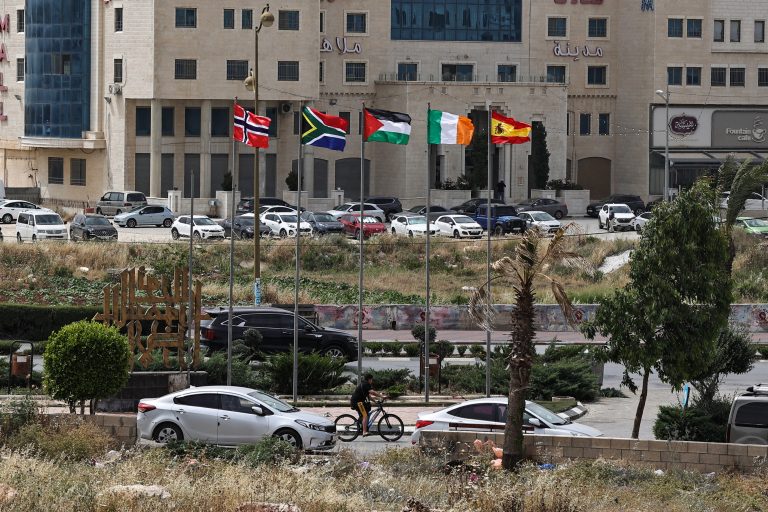 The flags of (L-R) Norway, South Africa, Palestine, Ireland, and Spain, are raised at an entrance of Ramallah city in the occupied West Bank on May 28, 2024. - Israel's war in Gaza since the October 7 attack has revived a global push for Palestinian statehood, with Norway, Spain and Ireland on May 28 becoming the latest to recognise a state of Palestine, in a move which has infuriated Israel, and brought to 145 the number of UN member states out of 193 to have done so. (Photo by Zain JAAFAR / AFP)