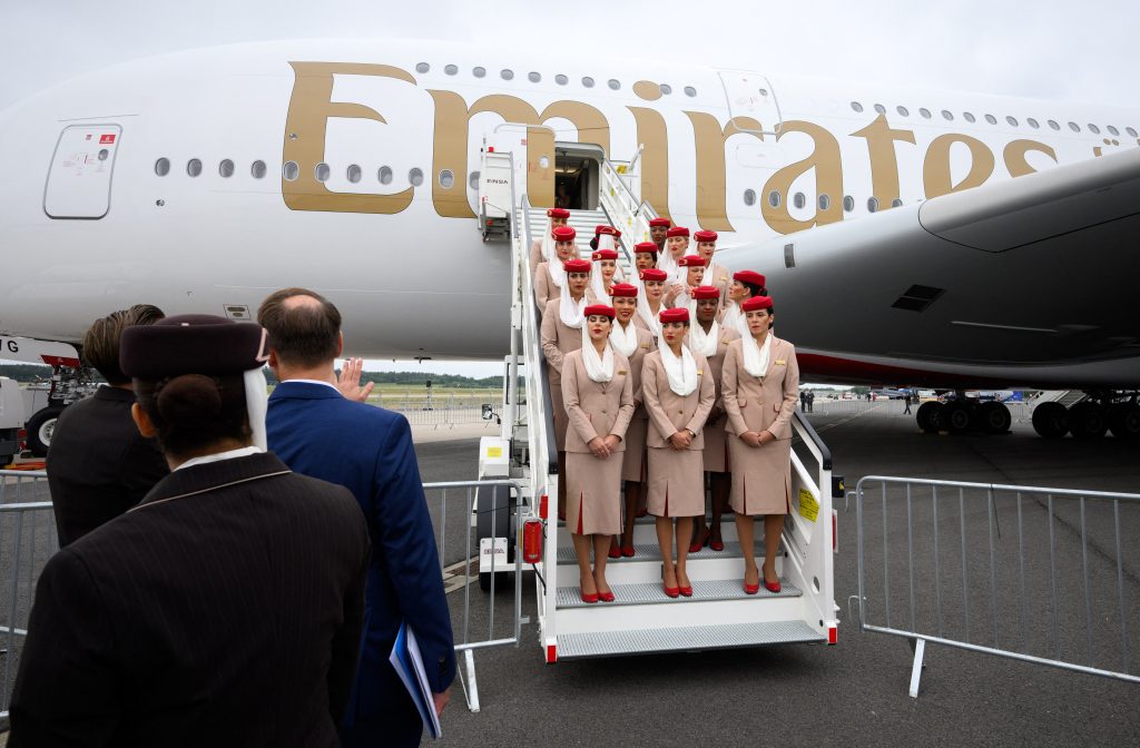 03 June 2024, Brandenburg, Schönefeld: A crew from Emirates airline has its photo taken on the steps in front of an Airbus A380-800 two days before the start of the International Aerospace Exhibition at Berlin Brandenburg Airport (BER). Around 600 exhibitors from 30 countries will be showcasing numerous aircraft and aerospace innovations at the "Innovation Fair of the Aerospace Industry", which takes place from 5 to 9 June 2024. Photo: Bernd von Jutrczenka/dpa (Photo by BERND VON JUTRCZENKA / DPA / dpa Picture-Alliance via AFP)