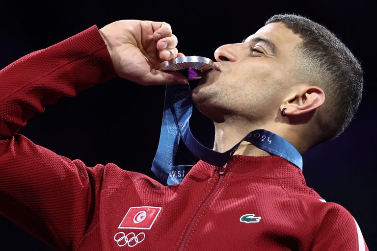 Silver medallist Tunisia's Fares Ferjani celebrates on the podium during the medal ceremony for the men's sabre individual competition during the Paris 2024 Olympic Games at the Grand Palais in Paris, on July 27, 2024. (Photo by Franck FIFE / AFP)