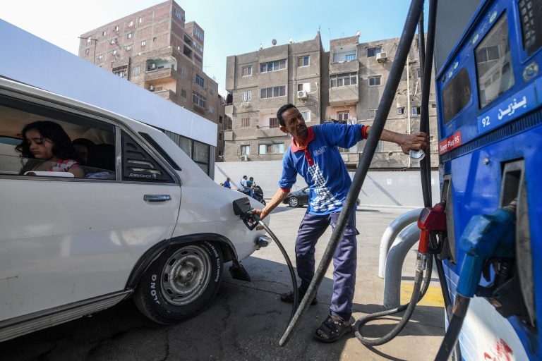 A worker fills the tank of a vehicle at a petrol station in Cairo on July 26, 2024, as Egypts government announced yesterday a new increase in fuel prices. - Egypt announced on July 25 a 15-percent increase in petrol prices, part of a reform package requested by the International Monetary Fund to proceed with a $5 billion loan to the cash-strapped government. (Photo by Ahmed HASAN / AFP)
