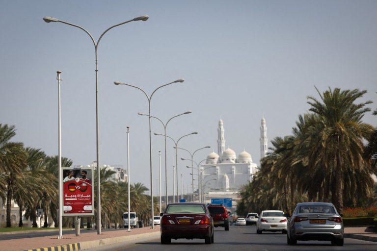 14 November 2022, Oman, Maskat: An advertising display indicating the friendly match between the German national soccer team and the national team of Oman can be seen on a street next to the stadium. With the friendly match on Nov. 16, 2022, the national team of Oman wants to prepare for the start of the World Cup at the Sultan Qabus Sports Center in Muscat. The Mohammed Al Ameen Mosque can be seen in the background. Photo: Christian Charisius/dpa - IMPORTANT NOTE: In accordance with the requirements of the DFL Deutsche Fußball Liga and the DFB Deutscher Fußball-Bund, it is prohibited to use or have used photographs taken in the stadium and/or of the match in the form of sequence pictures and/or video-like photo series. (Photo by CHRISTIAN CHARISIUS / DPA / dpa Picture-Alliance via AFP)