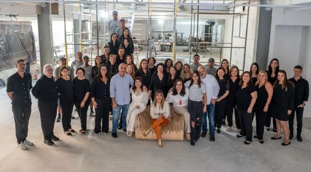 Assaf siblings with staff at the chain's 40th anniversary in 2023, at a store under development