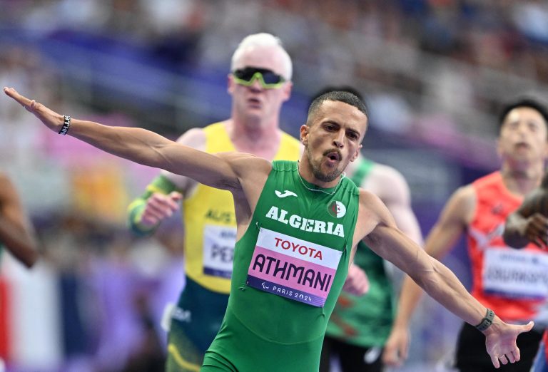 PARIS, FRANCE - SEPTEMBER 01: Skander Djamil Athmani of Algeria secures the first place in Para Athletics Men's 100m - T13 at the Paris 2024 Olympics, celebrates with Kare Adenegan (L) of Great Britain in France on September 1, 2024. Mustafa Yalcin / Anadolu (Photo by MUSTAFA YALCIN / ANADOLU / Anadolu via AFP)