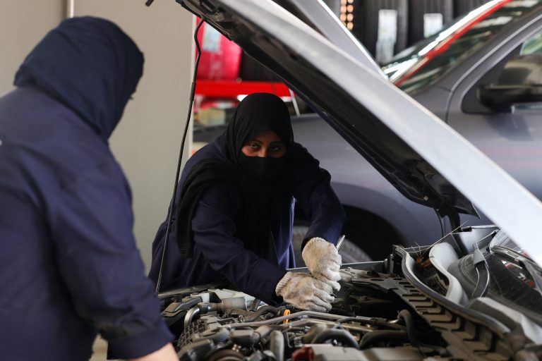 Saudis target more female workforce participation A picture taken May 26, 2022 shows Ghada Ahmed (R) working on a costumer's car at an auto quick service garage in Jeddah City. An auto repair garage in Saudi Arabia is turning to an untapped source for new mechanics: Saudi women, who just four years ago weren't even allowed to drive. At the Petromin Express garage in Jeddah, on the Red Sea coast, new female recruits check oil and change tires alongside their male counterparts, part of a nationwide push to bring more women into the workforce. (Photo by Fayez Nureldine / AFP)