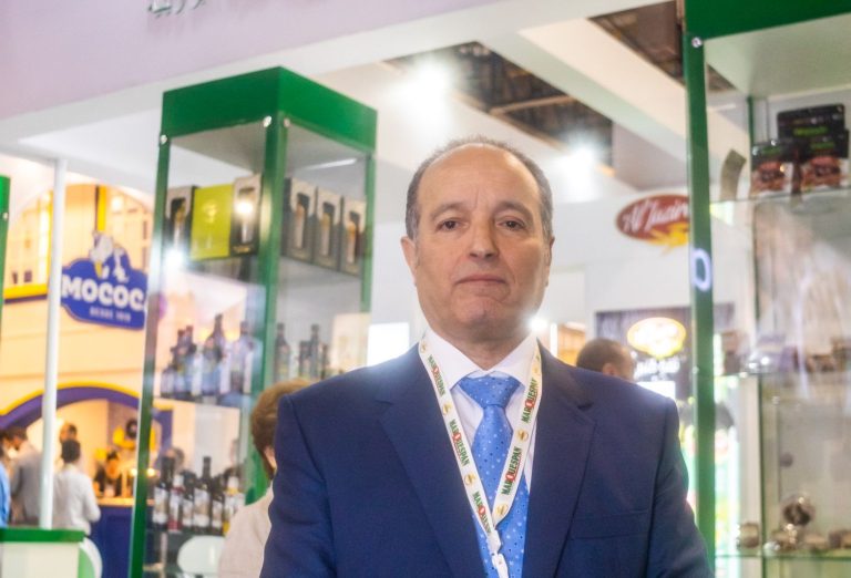 Tunisian Ambassador to Brazil, Nabil Lakhal, in front of a stand showcasing Tunisian products, including olive oils, at the APAS Show 2024