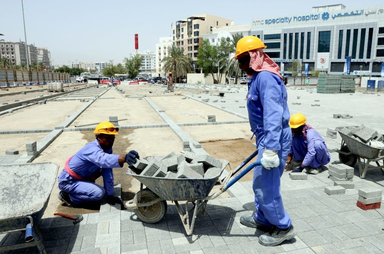 Foreign labourers work at a construction site in the Omani capital Muscat, amid scorching heat, on June 21, 2022. Between June and August, the oil-producing Gulf countries, Saudi Arabia, United Arab Emirates, Qatar, Kuwait, Bahrain and Oman, ban working outside for about four hours starting from noon. Workers return to their dormitories or nestle in any shade they can find. But increasingly, the high summer temperatures are unbearable even in the shade. (Photo by MOHAMMED MAHJOUB / AFP)