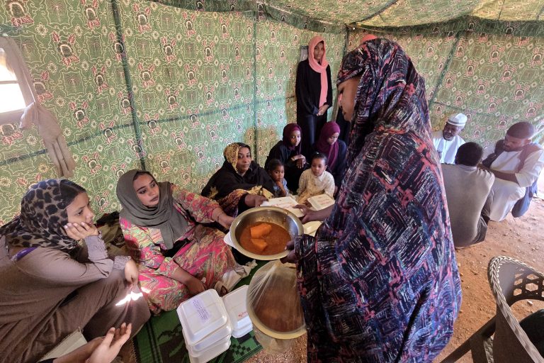 A woman collects food at a location set up by a local humanitarian organisation to donate meals and medication to people displaced by the war in Sudan, in Meroe in the country's Northern State, on January 9, 2025. Famine has already gripped five areas across Sudan, according to a report last month by the Integrated Food Security Phase Classification (IPC), a UN-backed assessment. The country has endured 20 months of war between the army and the paramilitary Rapid Support Forces (RSF), killing tens of thousands and, according to the United Nations, uprooting 12 million in the world's largest displacement crisis. (Photo by AFP)
