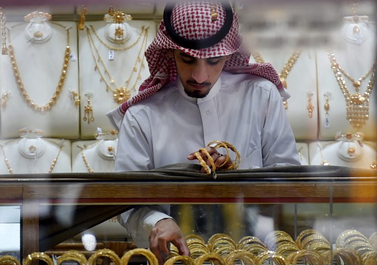 A Saudi man displays gold bracelets at his jewelry shop in Tiba market in the capital Riyadh on October 3, 2016. (Photo by FAYEZ NURELDINE / AFP)