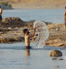 Iraqi Youths Swim in River