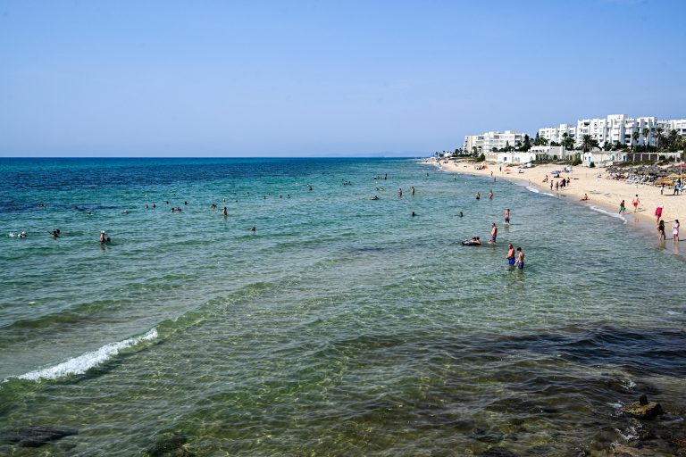 Brazil-Arab Gallery #13 People bathe and swim in the Mediterranean sea waters at a beach in the resort town of Hammamet in Tunisia's Nabeul province on August 26, 2025. Tunisia's tourism sector in 2025 marked the return of European, French, and British tourists after a decade-long slump caused by deadly attacks targeting holidaymakers and the COVID-19 coronavirus pandemic. (Photo by FETHI BELAID / AFP)