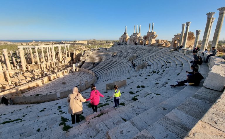 People visit the amphitheatre of the ancient Roman city of Leptis Magna, in the coastal Libyan city of Al-Khums, some 120Km east of the capital Tripoli, on February 4, 2022. (Photo by Mahmud TURKIA / AFP)