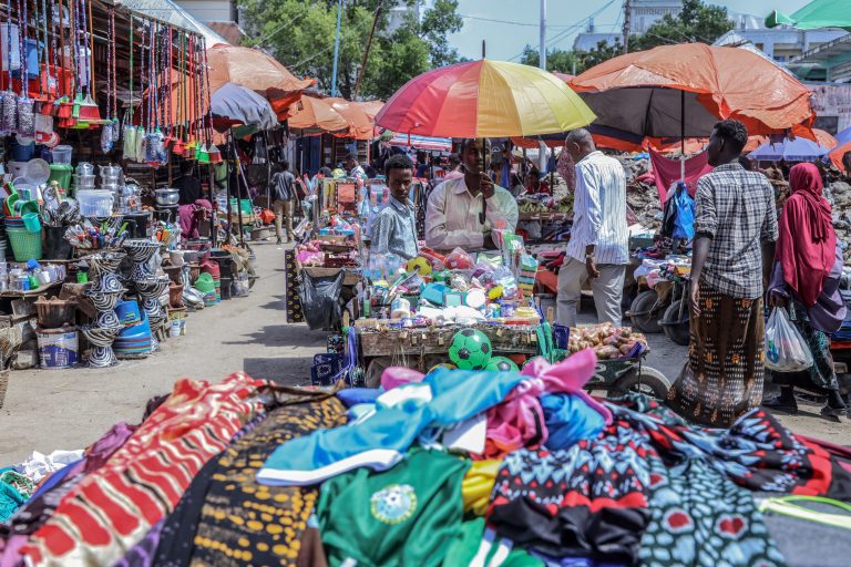 Climate affects Somalia’s growth A Somali man holds an umbrella while waiting for costumers next to his stall at the Hamarweyne Market in Mogadishu on December 14, 2023. Somalia will benefit from a major $4.5 billion debt reduction plan from international creditors, relating to its debt service, the International Monetary Fund (IMF) announced on December 13, 2023. Somalia has implemented a poverty reduction strategy for at least a year and has maintained good macroeconomic management, the IMF estimates. (Photo by Hassan Ali Elmi / AFP)
