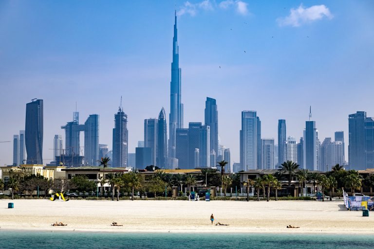 UAE wraps up World’s Coolest Winter campaign Burj Khalifa, the world's tallest building, adorns the Dubai skyline as people sunbathe on Jumerah beach, on January 30, 2025. (Photo by FADEL SENNA / AFP)