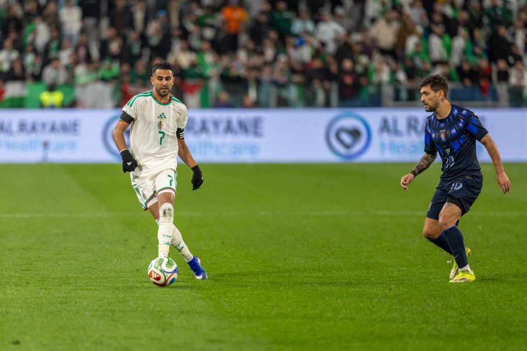 Riyad Mahrez (L) in a match against Uruguay: The country returns to the World Cup after eight years, buoyed by its recent results