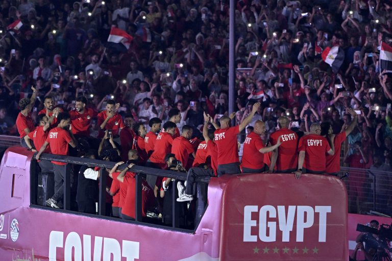 Brazil-Arab Gallery #65 Egypt's players wave from an open-top bus to cheering fans as they enter Cairo stadium on July 13, 2026, following their participation in the FIFA World Cup 2026 football tournament. (Photo by Khaled DESOUKI / AFP)